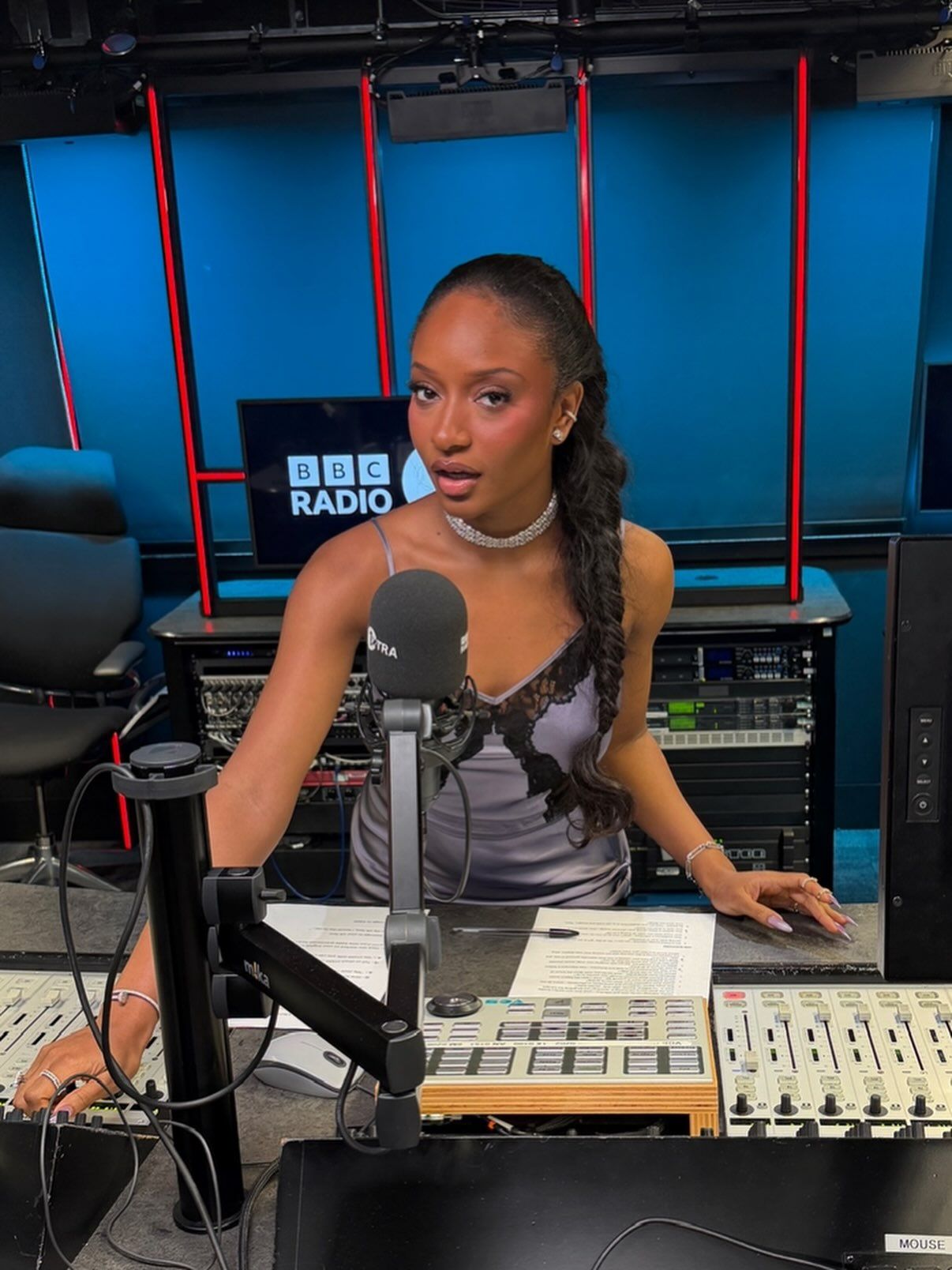 Ayra Starr at the BBC 1Xtra studio desk