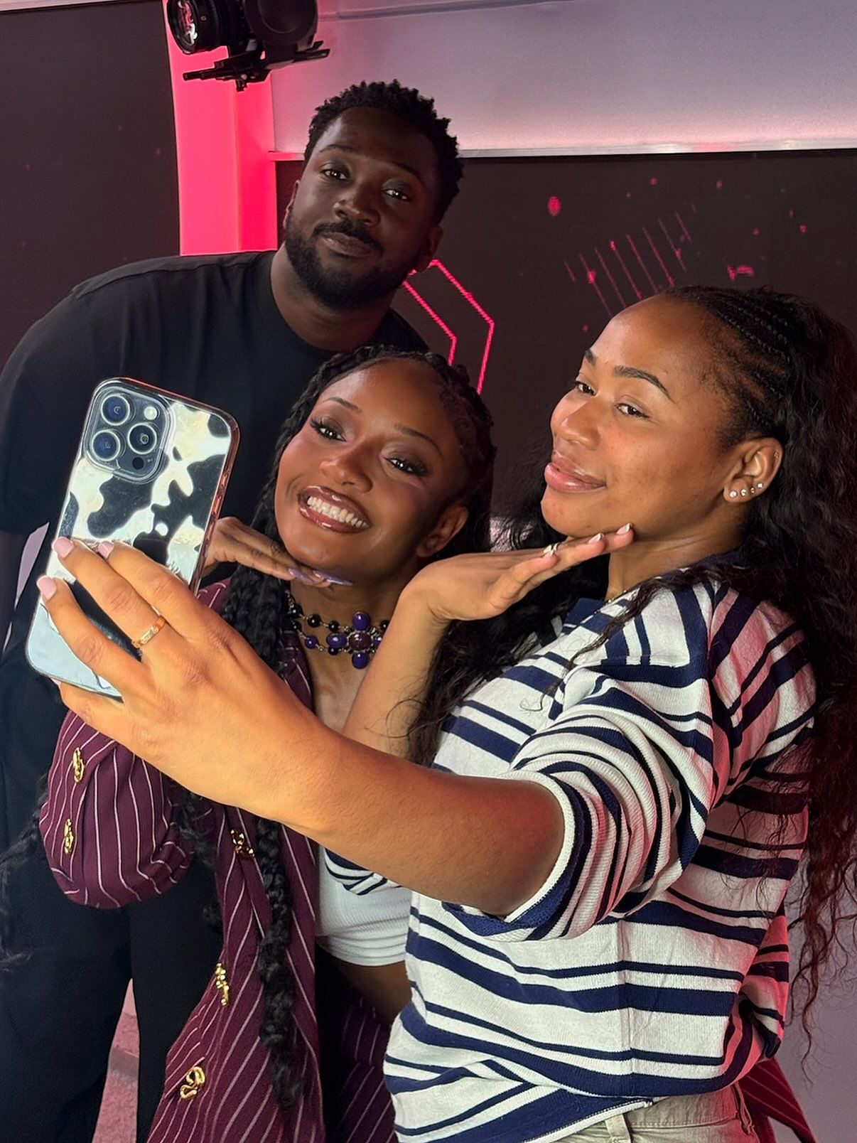 Ayra Starr taking a selfie with the Capital XTRA presenters