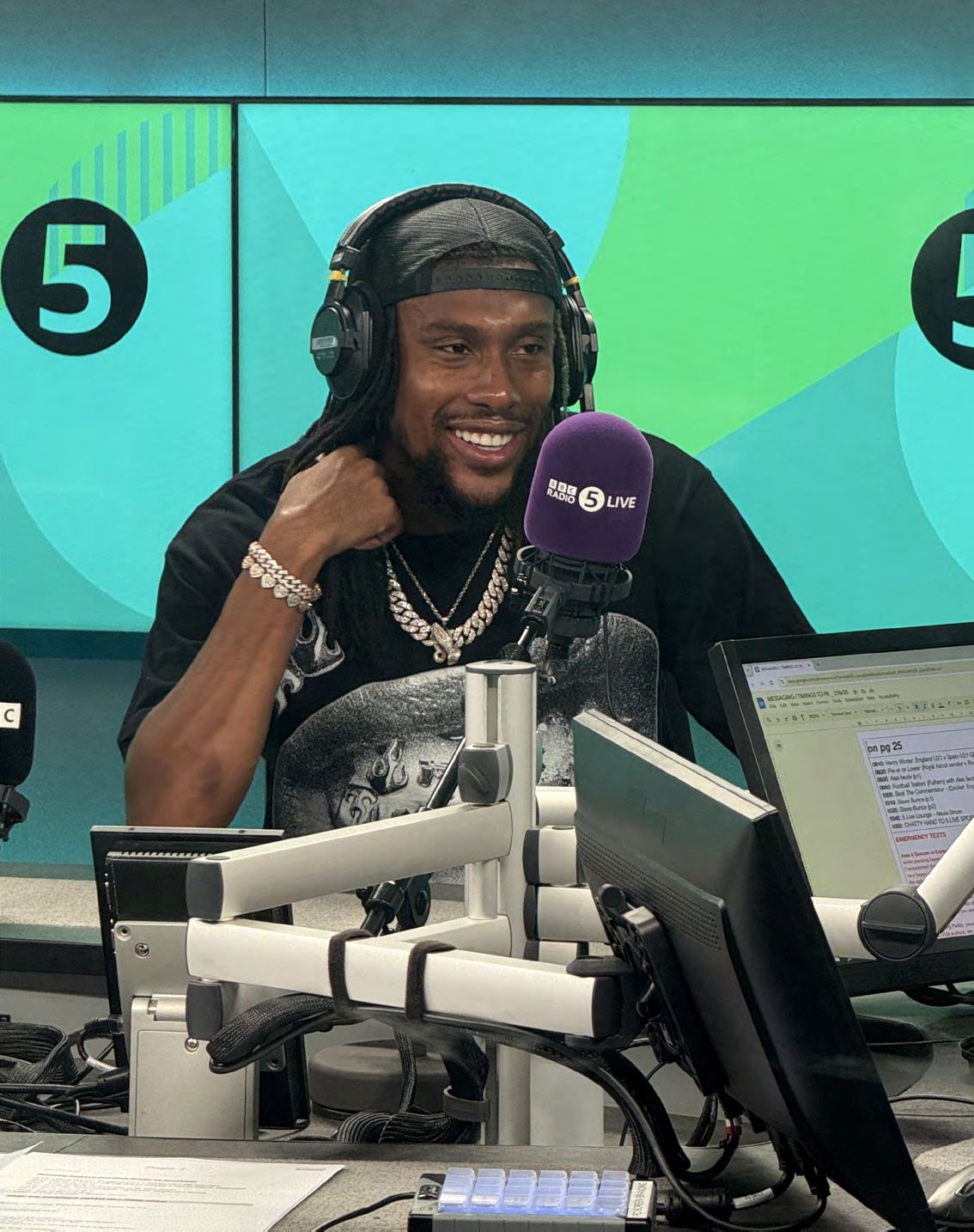 Alex Iwobi speaking into a BBC Radio 5 Live microphone