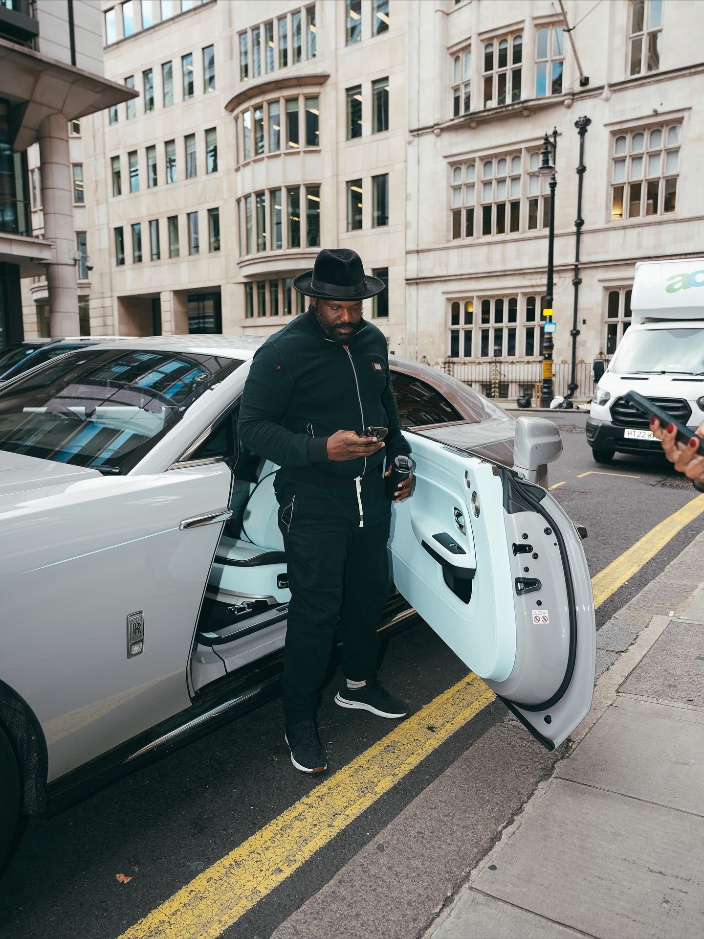 Derek Chisora beside a car in London, photographed for Noteworthy Media’s October 2025 post